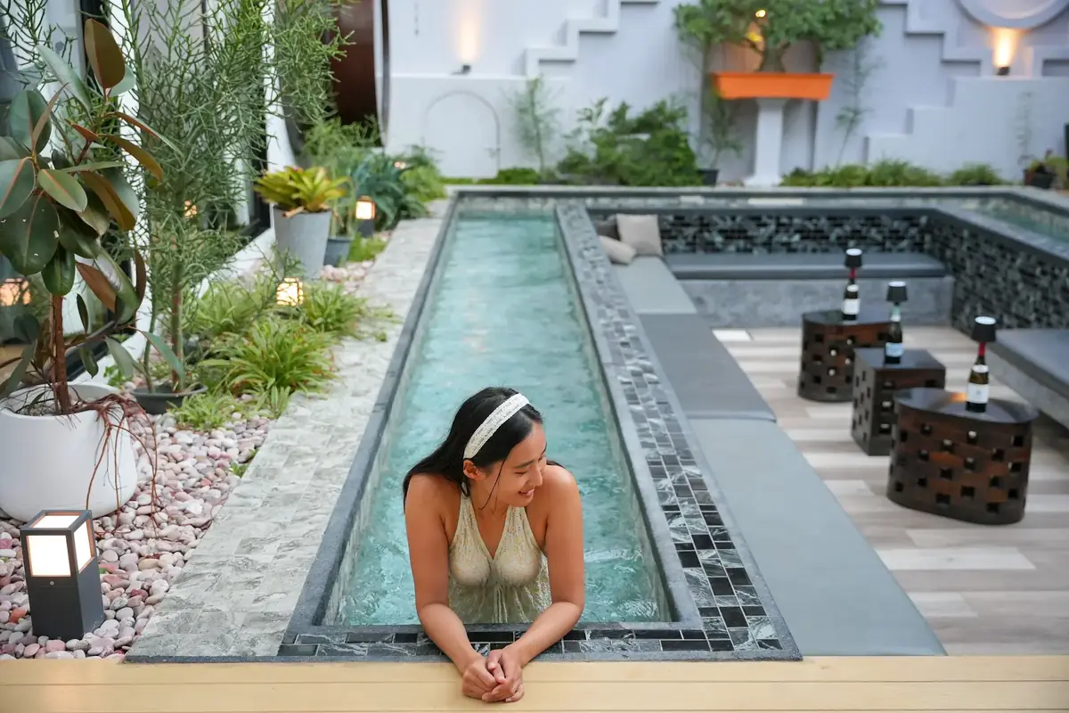 Long garden pool with a guest at the edge