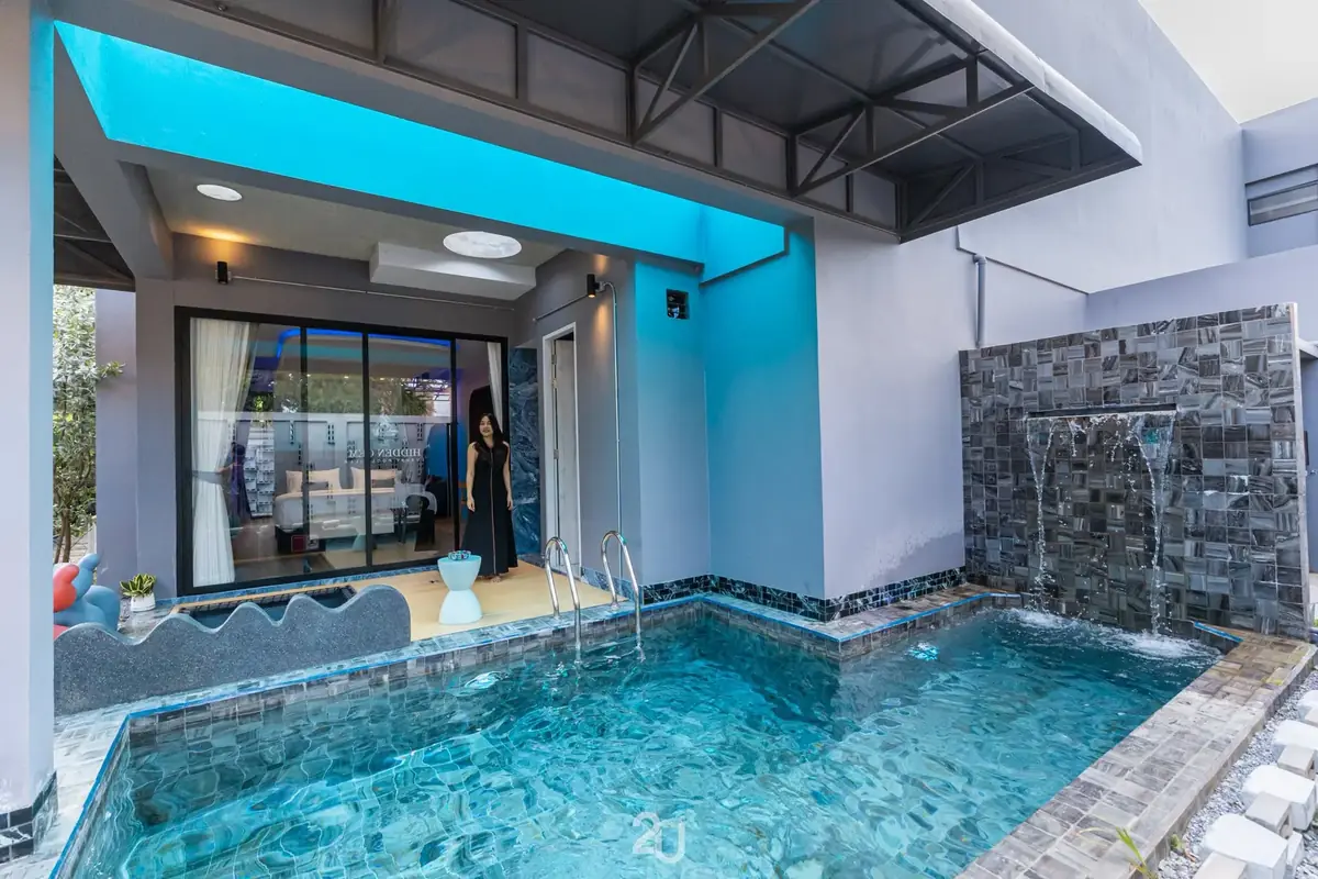 Pool with waterfall wall under a blue canopy